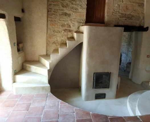 Intérieur de maison ancienne rénovée avec matériaux naturels et ambiance thermique équilibrée
